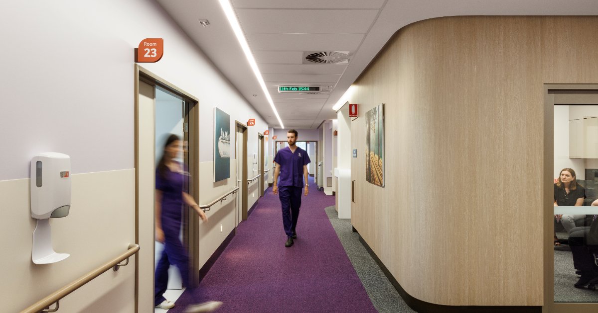 Staff walking along a ward corridor at Adeney Private Hospital